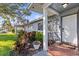 House entrance with decorative gate and well-manicured landscaping at 14241 113Th Ave, Largo, FL 33774