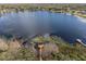 Aerial view of a peaceful lake with several docks and surrounding homes at 15728 Berea Dr, Odessa, FL 33556