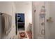 Modern bathroom with a glass enclosed shower and access to bedroom at 16843 Forge Surf St, Land O Lakes, FL 34638