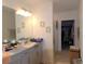 Elegant bathroom with double vanity, large mirror, and walk-in shower at 16843 Forge Surf St, Land O Lakes, FL 34638