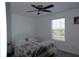 Simple bedroom with full-size bed and ceiling fan at 16843 Forge Surf St, Land O Lakes, FL 34638
