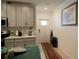 Kitchen entryway with white door and rug at 16843 Forge Surf St, Land O Lakes, FL 34638