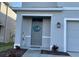 Home entrance with a charming beach themed wreath, decorative accents, and a welcoming ambiance at 16949 Secret Meadow Dr, Odessa, FL 33556