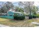 Adorable teal cottage with well-manicured lawn and picket fence at 2600 46Th S St, Gulfport, FL 33711