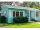 Charming light teal home with white shutters, landscaping, and walkway at 2600 46Th S St, Gulfport, FL 33711