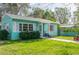 Quaint teal home with white picket fence and lush green lawn at 2600 46Th S St, Gulfport, FL 33711