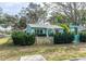 Cute teal home with green shrubs and a white fence at 2600 46Th S St, Gulfport, FL 33711