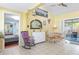 Sunlit living room with rocking chair, dining area, and bedroom view at 2600 46Th S St, Gulfport, FL 33711