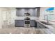 Modern kitchen with gray cabinets and granite countertops at 2734 Sand Hollow Ct # 1, Clearwater, FL 33761