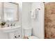 Clean bathroom with white pedestal sink and shower at 2740 E Vina Del Mar Blvd, St Pete Beach, FL 33706