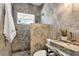 Modern bathroom with stone sink and shower at 2740 E Vina Del Mar Blvd, St Pete Beach, FL 33706