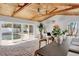 Open dining area with wood beams, sliding doors, and pool view at 2740 E Vina Del Mar Blvd, St Pete Beach, FL 33706