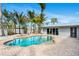 Stunning kidney shaped pool with brick patio and palms at 2740 E Vina Del Mar Blvd, St Pete Beach, FL 33706