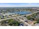 Wide aerial view of the neighborhood and surrounding lake at 306 Scott Ct, Palm Harbor, FL 34684