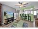 Living room with a large TV, green coffee table and view into the kitchen at 306 Scott Ct, Palm Harbor, FL 34684