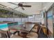 Screened patio with hot tub, dining table, and view of the refreshing pool at 306 Scott Ct, Palm Harbor, FL 34684