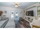 Cozy living room featuring French doors and built-in entertainment center at 37443 Blueberry Ct, Zephyrhills, FL 33542