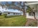 Spacious backyard with lush lawn and mature shade tree at 4526 101St N Ave, Pinellas Park, FL 33782