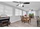 Bright dining area with table and chairs, TV, and piano at 4526 101St N Ave, Pinellas Park, FL 33782