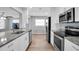 Modern kitchen with white cabinets, granite countertops, and stainless steel appliances at 4526 101St N Ave, Pinellas Park, FL 33782