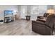 Living room with gray walls, laminate floors and brown recliner chairs at 4526 101St N Ave, Pinellas Park, FL 33782