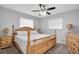 Large main bedroom with a wooden bed frame and ceiling fan at 4526 101St N Ave, Pinellas Park, FL 33782