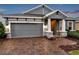 Two-car garage and front entrance with brick pavers at 4559 Ballantrae Blvd, Land O Lakes, FL 34638