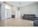 Living room with tile floors and a black leather couch at 4709 Red Warbler Ln, Valrico, FL 33596