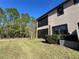 Backyard view of home with screened patio at 4899 Isola Ct, Wesley Chapel, FL 33543