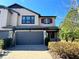Two-story house with a two-car garage and landscaping at 4899 Isola Ct, Wesley Chapel, FL 33543