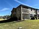 Two-story house with a screened porch and backyard at 4899 Isola Ct, Wesley Chapel, FL 33543