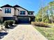 Two-story house with a two-car garage and landscaping at 4899 Isola Ct, Wesley Chapel, FL 33543