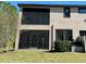 Two-story house with a screened porch and backyard at 4899 Isola Ct, Wesley Chapel, FL 33543