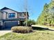 Two-story house with a two-car garage and a side yard at 4899 Isola Ct, Wesley Chapel, FL 33543