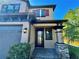 Two-story house with a front door and landscaping at 4899 Isola Ct, Wesley Chapel, FL 33543