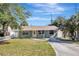 Charming light green house with a well-maintained lawn and a paved driveway at 5211 2Nd S Ave, St Petersburg, FL 33707