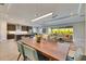Bright dining room with wooden table, modern chairs, and open view to the kitchen and living area at 5612 Limelight Dr, Apollo Beach, FL 33572