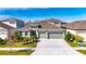 Two-story house with a three-car garage and landscaped front yard at 5612 Limelight Dr, Apollo Beach, FL 33572
