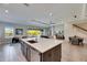 Open kitchen with large island, stainless steel appliances, and views to living and dining areas at 5612 Limelight Dr, Apollo Beach, FL 33572