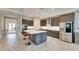 Modern kitchen with gray cabinets, stainless steel appliances, and a large island at 5612 Limelight Dr, Apollo Beach, FL 33572