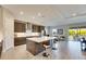 Modern kitchen with gray cabinets, an expansive island, and stainless steel appliances at 5612 Limelight Dr, Apollo Beach, FL 33572