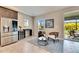 Cozy kitchenette with stainless steel appliances and wine cooler, adjacent to a patio at 5612 Limelight Dr, Apollo Beach, FL 33572