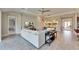 Open concept living room with large sectional sofa and tile floors, offering views into other areas at 5612 Limelight Dr, Apollo Beach, FL 33572