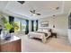 Spacious main bedroom with plush carpet, large windows and ceiling fan at 5612 Limelight Dr, Apollo Beach, FL 33572