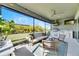 Relaxing screened patio features an outdoor kitchen, seating area, and lush landscaping at 5612 Limelight Dr, Apollo Beach, FL 33572