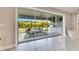 View through sliding glass doors to a screened patio with outdoor kitchen at 5612 Limelight Dr, Apollo Beach, FL 33572