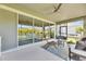 Relaxing screened patio featuring comfy seating and ceiling fan at 5612 Limelight Dr, Apollo Beach, FL 33572