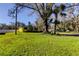 Yellow house with a grassy yard and mature trees at 6317 20Th S Ave, Tampa, FL 33619