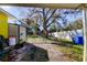 Side yard view with shed, gate, and propane tank at 6317 20Th S Ave, Tampa, FL 33619