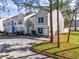 Row of townhomes with gray siding, white trim, and landscaping at 6640 121St Ave # 6, Largo, FL 33773